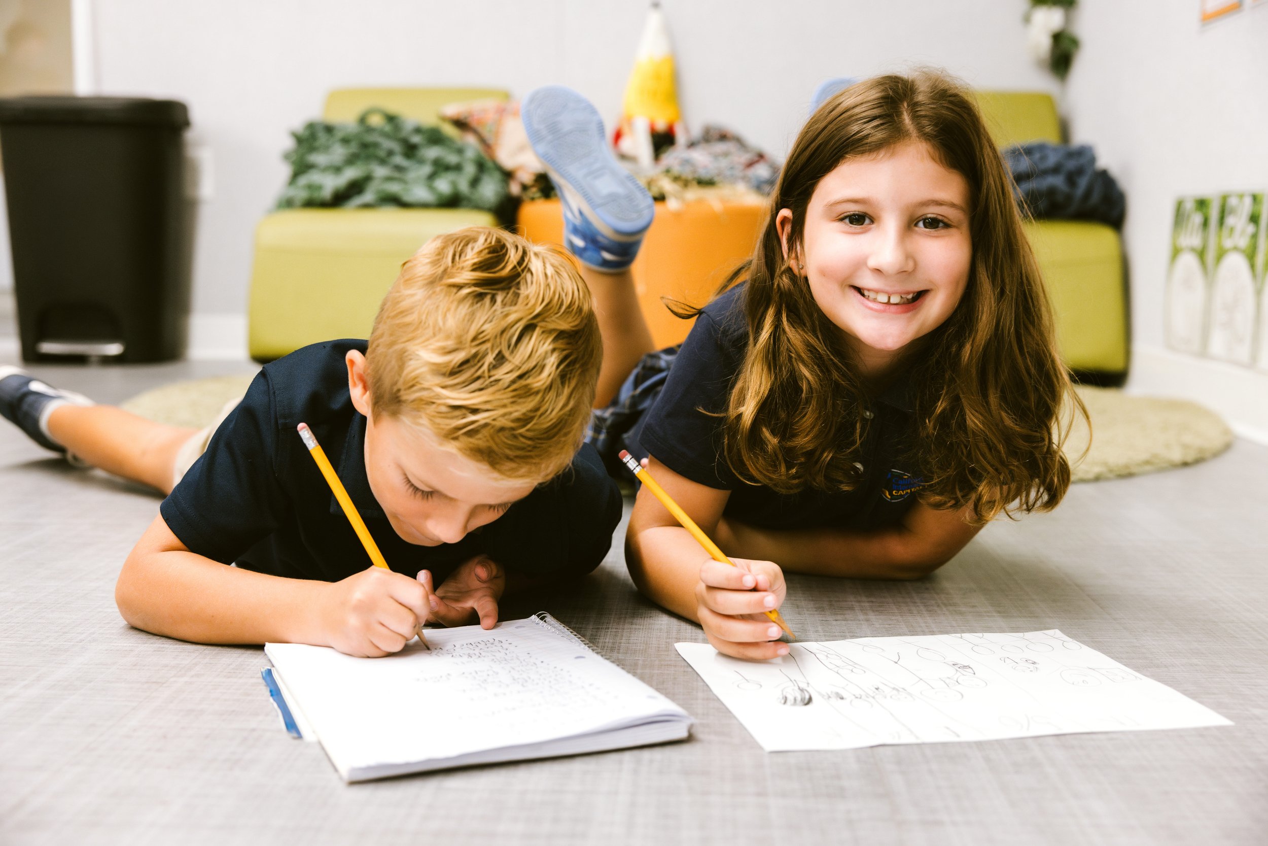 Two children practicing handwriting skills.